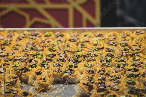 Baklawa  baklawa  traditional and authentic Middle Eastern Arabian pastry  fried dough wires  honey  in the shape of an open square. Stuffed with pistachios. Mahane Yehuda Market  Jerusalem.