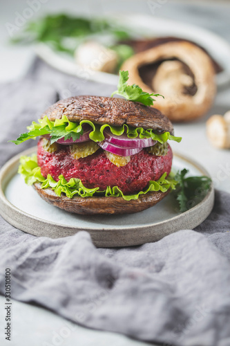 Portobello mushroom bun burger with beetroot cutlet. Vegan, gluten free burger photo