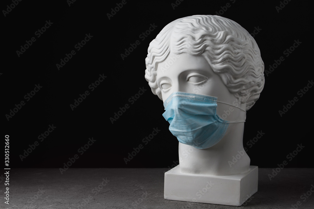 Medical mask on an antique statue. Virus epidemic medical care Medical mask on an antique statue. Virus epidemic medical care