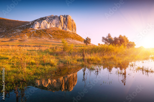 White rocky mountain reflected in a lake