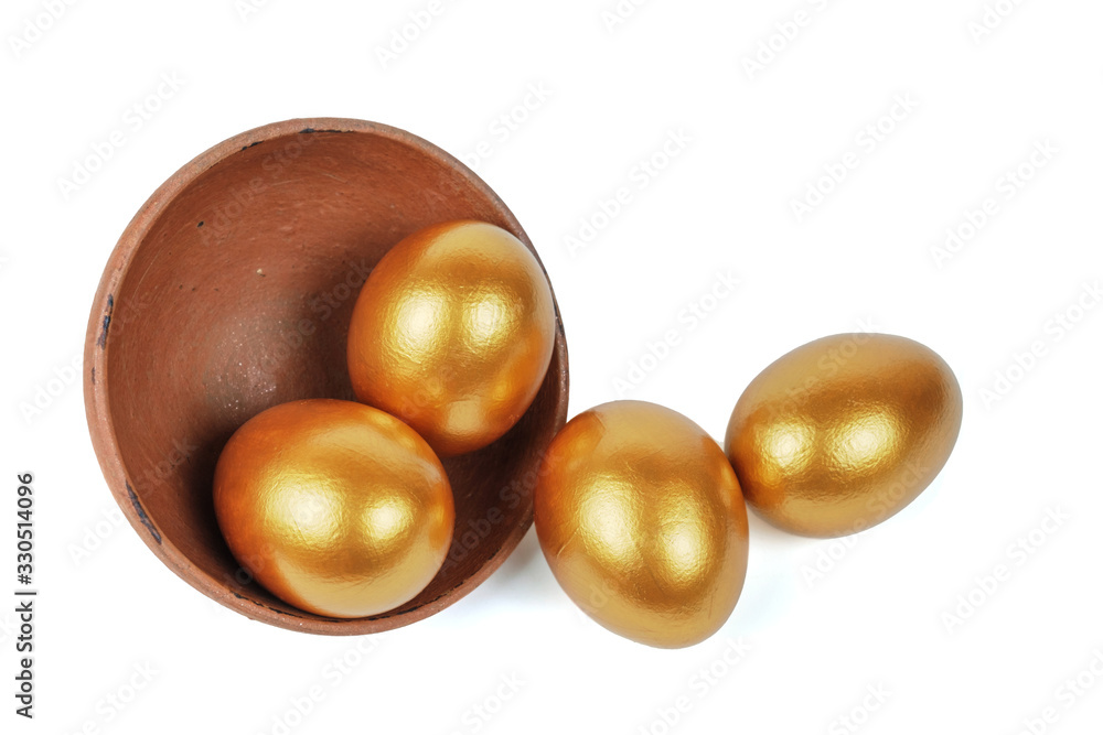 Golden Easter eggs in a clay bowl Golden Easter eggs in a clay bowl