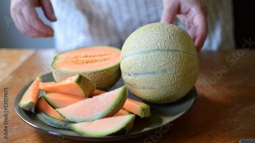 The cook opens the melon.