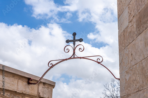 Photo A metal cross is attached above the entrance to the Greek Akeldama Monastery in
