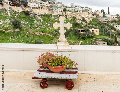 Fototapeta A large stone cross stands on the balcony of the Greek Akeldama Monastery in the