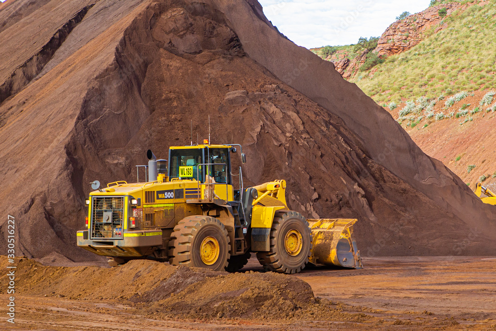 Loader at iron ore stock pile Loader at iron ore stock pile
