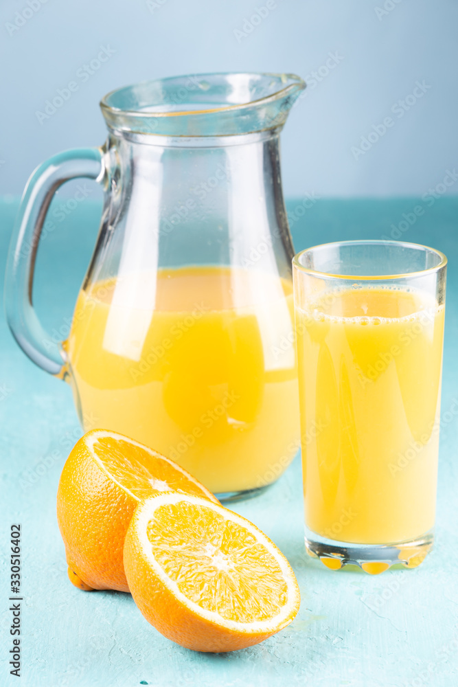 Jug with orange juice on a blue background Jug with orange juice on a blue background