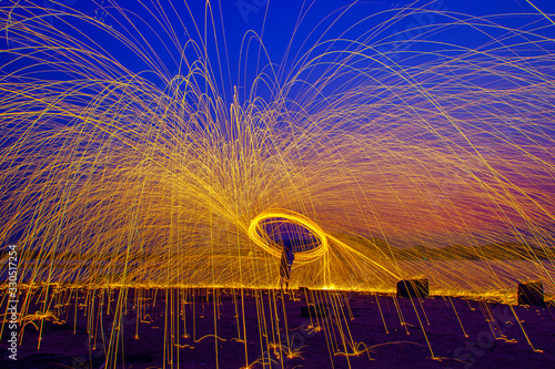 Burning Steel Wool spinning. Showers of glowing sparks from spinning steel wool
