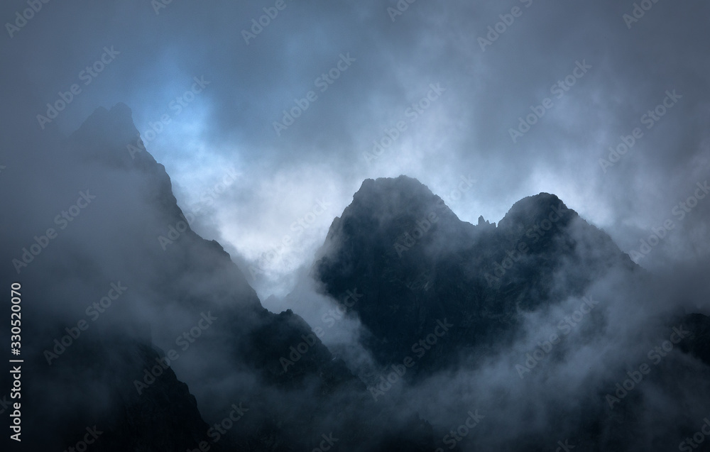 Dark Granite Mountains in Clouds
