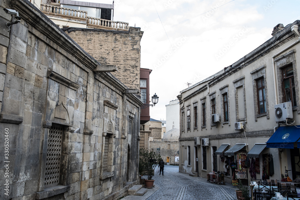 Fototapeta premium Empty street in old city of Baku, Azerbaijan. Old city Baku. Inner City buildings.