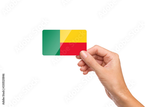 Beautiful hand holding Benin flag card on white background