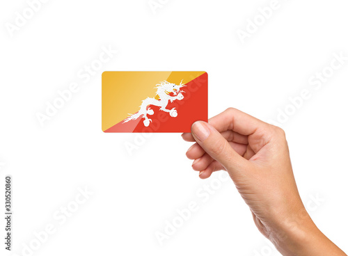 Beautiful hand holding Bhutan flag card on white background © Aaftab Sheikh