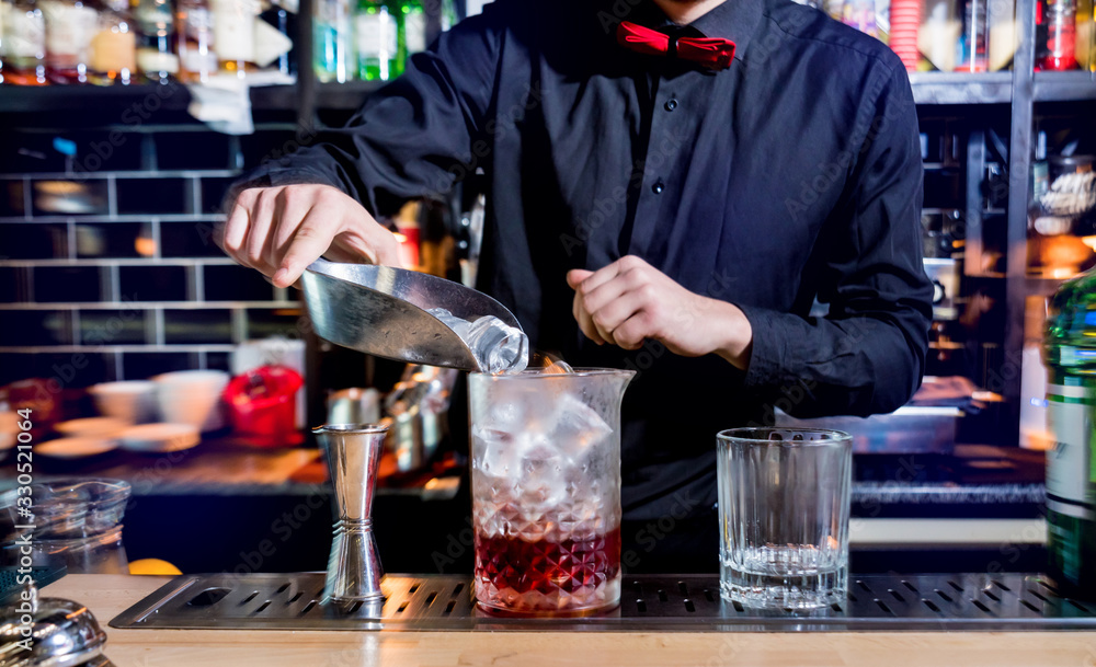 Bartender is making cocktail at bar counter. Fresh cocktails. 