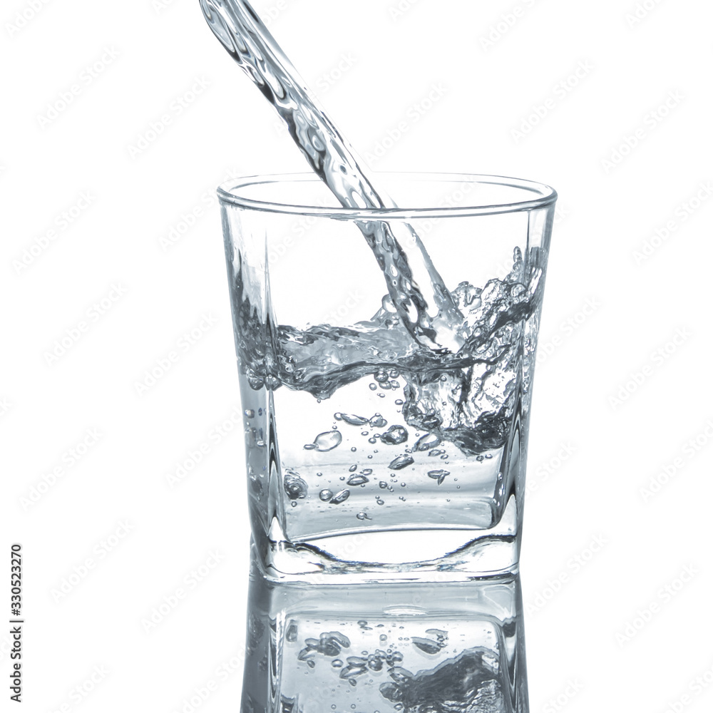 Pouring clean drinking water on a transparent glass. For health concepts. Isolated white background Pouring clean drinking water on a transparent glass. For health concepts. Isolated white background