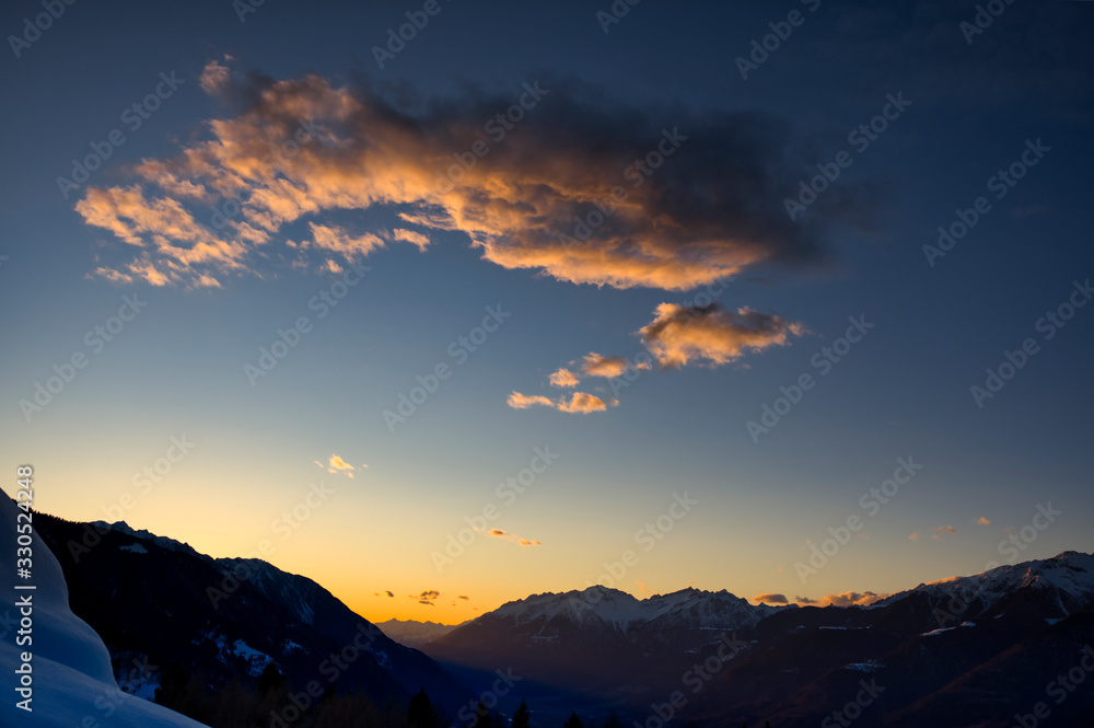 Sunset in Valtellina with the mountain snowcapped.