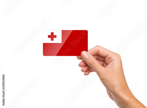 Beautiful hand holding Tonga flag card on white background