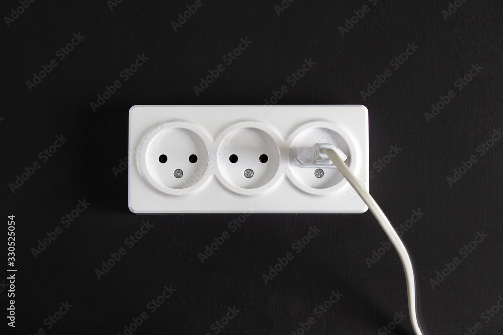 Light socket with three connectors on a black background in a