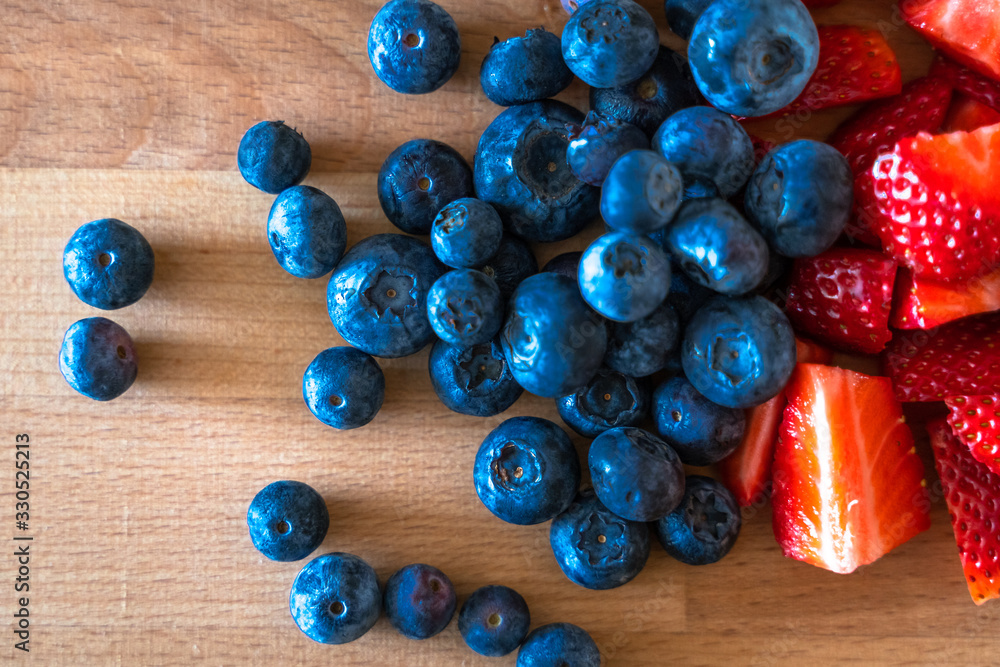 Details of strawberries and blueberries in a wood table Details of strawberries and blueberries in a wood table