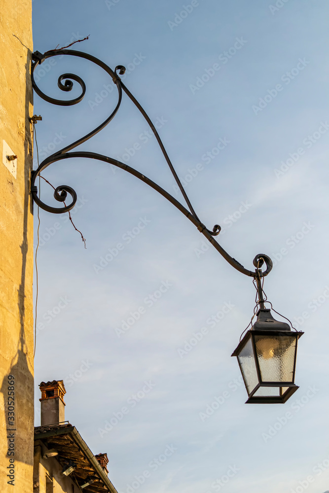 Lantern in art nouveau style, hanging on a wall