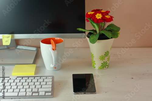 partial view of a minivalist desk table with a seasonal plant. photo