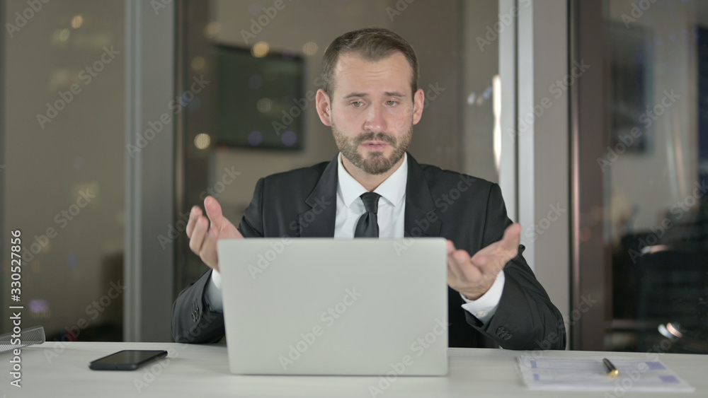 The Businessman Discussing During Video Chat at Night The Businessman Discussing During Video Chat at Night