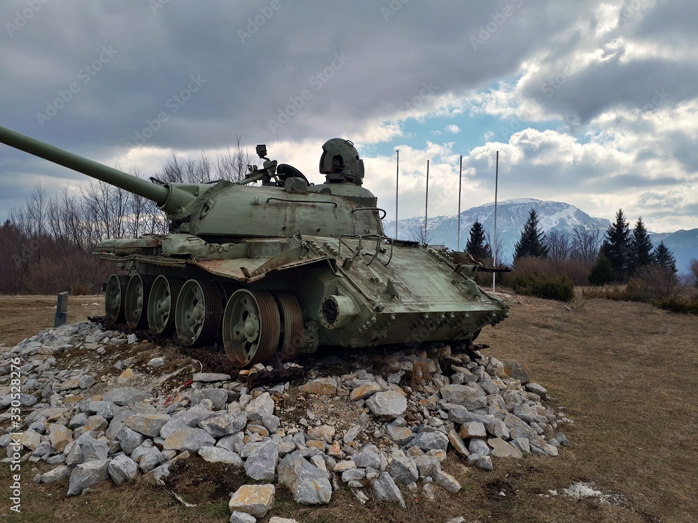 Old soviet tank destroyed in 90's, now placed on a meadow as a monument