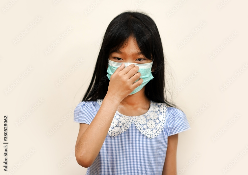 young woman sneezing, The girl is wearing a sanitary mask and squeezing the mask with the fingers on the ridge of the nose. on a white background with copy space. young woman sneezing, The girl is wearing a sanitary mask and squeezing the mask with the fingers on the ridge of the nose. on a white background with copy space.