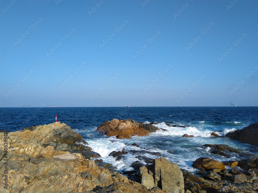 Long shot of blue sky and calm sea