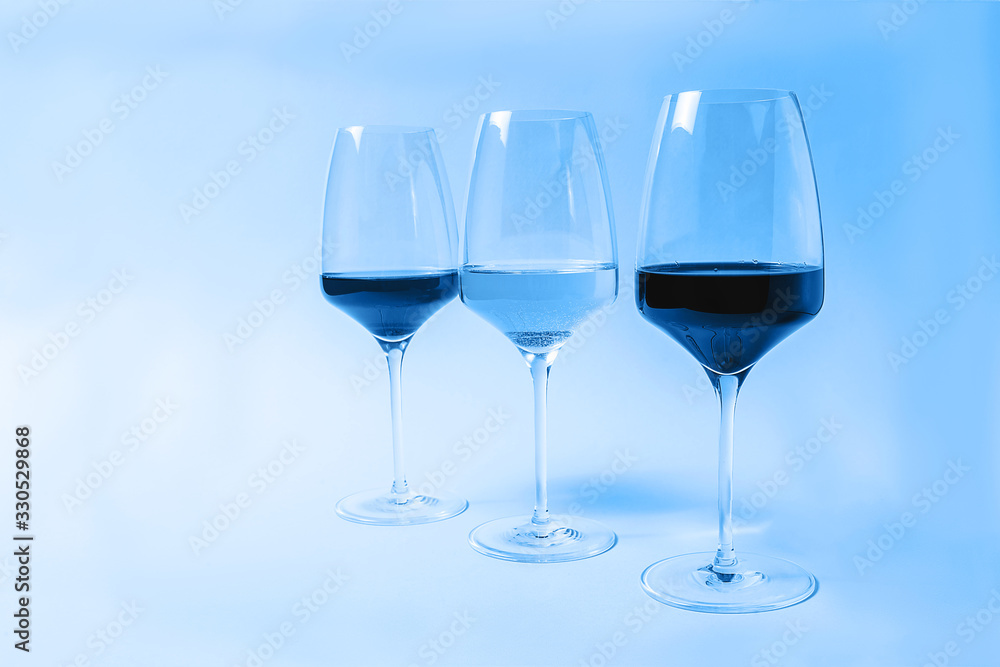 Wine in glasses toned in classic blue color. Wine in glasses toned in classic blue color.