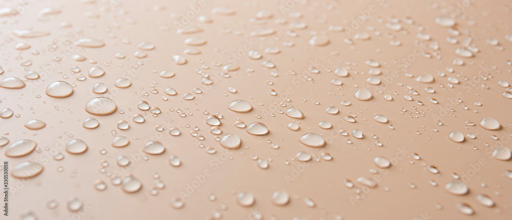 Many different drops of water rain on a beige background - obrazy, fototapety, plakaty 