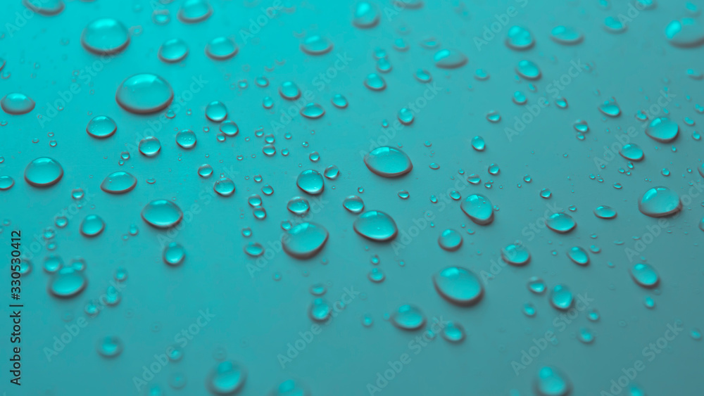 Many different drops of water rain on a turquoise background