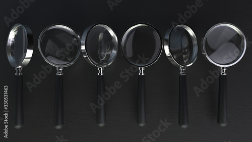 3d render of a line chrome magnifying glass on a black background with depth of field