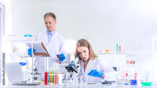 Two scientists researching for some confidential in chemical laboratory