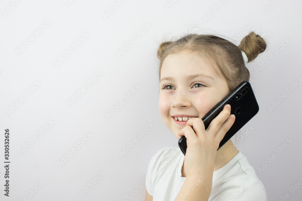 little girl talking on a smartphone , copy space, a place to place ads, text. little girl talking on a smartphone , copy space, a place to place ads, text.