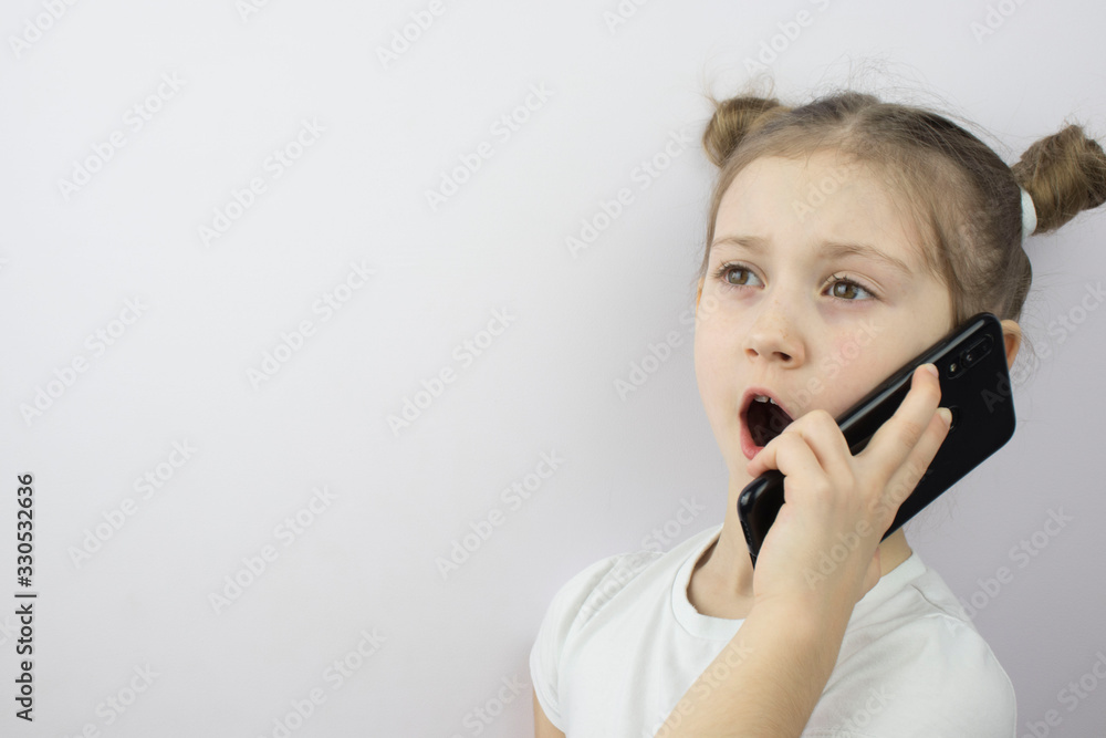little girl talking on a smartphone , copy space, a place to place ads, text. little girl talking on a smartphone , copy space, a place to place ads, text.