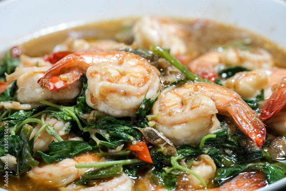Stir fried shrimp with basil on a white plate. Thai food. Stir fried shrimp with basil on a white plate. Thai food.
