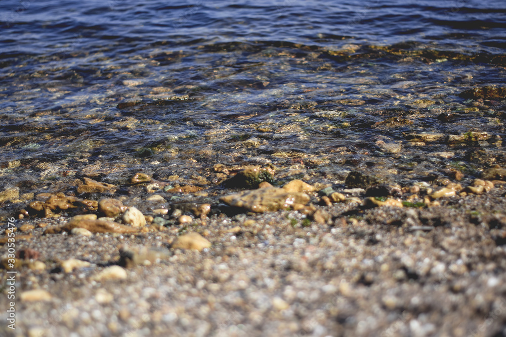 The Black Sea with clear water, in which stones, shells and sand are visible The Black Sea with clear water, in which stones, shells and sand are visible