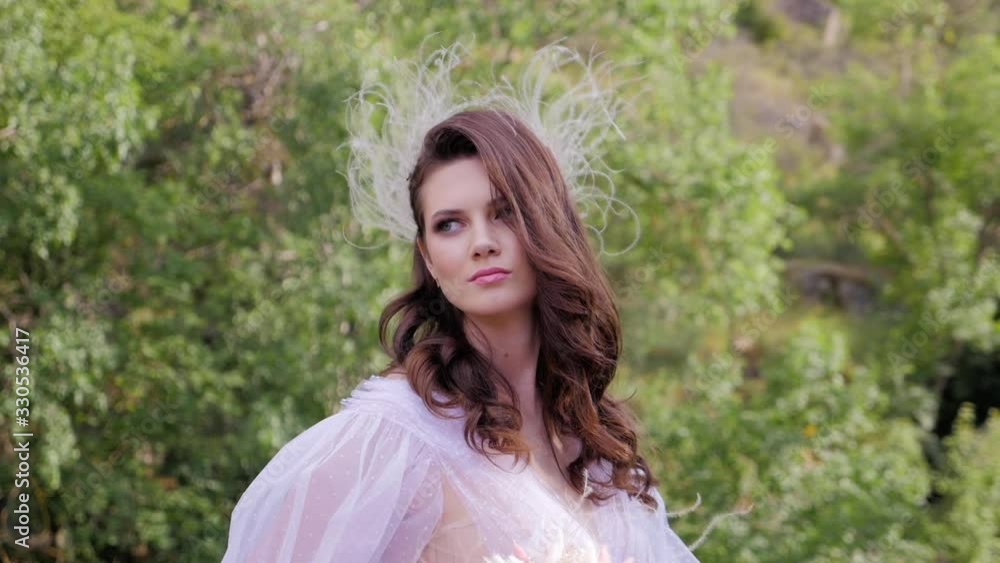 Close up portrait of pretty brunette girl in a white dress posing outdoors enjoying summer. Close up portrait of pretty brunette girl in a white dress posing outdoors enjoying summer.