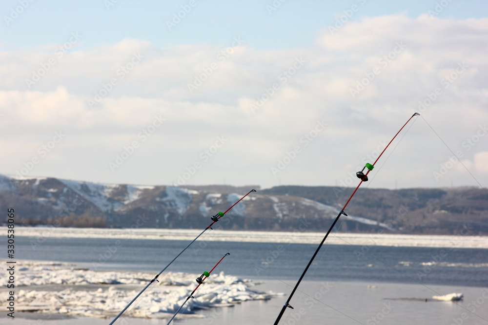 fishing gear on a blurred background of a spring river with floating ice floes fishing gear on a blurred background of a spring river with floating ice floes