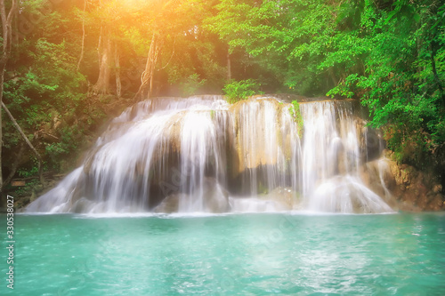 The beautiful Erawan cascade waterfall with turquoise water like heaven and sunlight at the tropical forest ,Kanchanaburi National Park, Thailand © Anukool