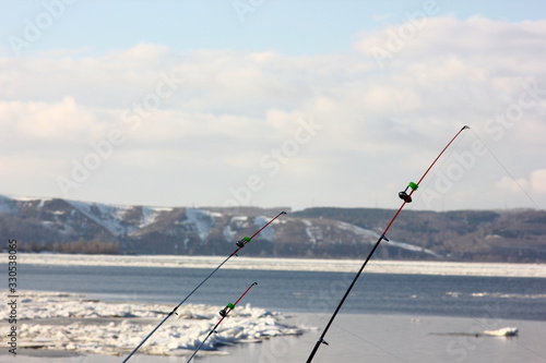 fishing gear on a blurred background of a spring river with floating ice floes