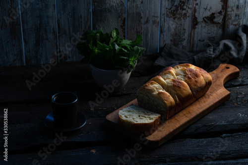 brioche bread on a wooden board, rustic backdrop, old wooden background