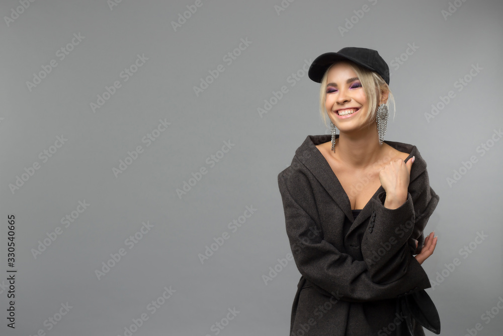 beautiful young girl in a cap on a gray background. Copy space beautiful young girl in a cap on a gray background. Copy space