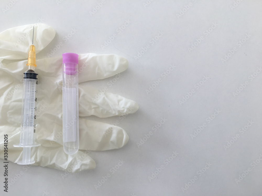 syringe and laboratory check up blood tube collection on glove in medical anual check up concept with copy space syringe and laboratory check up blood tube collection on glove in medical anual check up concept with copy space