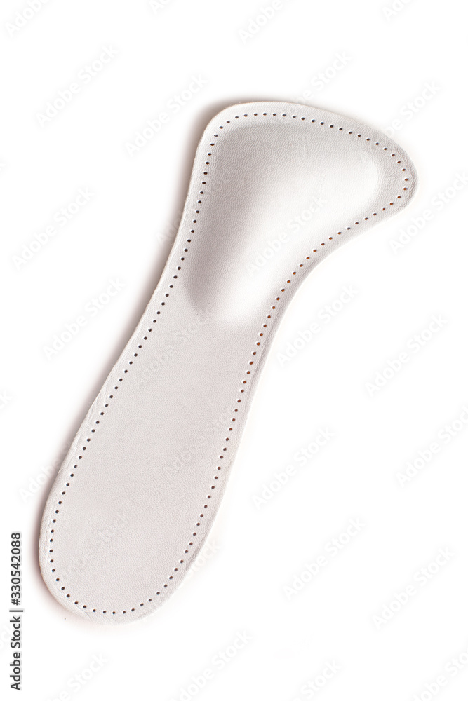Isolated orthopedic insole on a white background. Treatment and prevention of flat feet and foot diseases. Foot care, comfort for the feet. Wear comfortable shoes. Medical insoles. Isolated orthopedic insole on a white background. Treatment and prevention of flat feet and foot diseases. Foot care, comfort for the feet. Wear comfortable shoes. Medical insoles.
