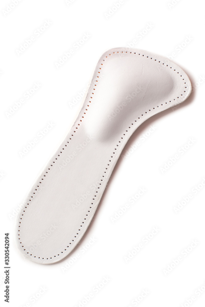 Isolated orthopedic insole on a white background. Treatment and prevention of flat feet and foot diseases. Foot care, comfort for the feet. Wear comfortable shoes. Medical insoles. Isolated orthopedic insole on a white background. Treatment and prevention of flat feet and foot diseases. Foot care, comfort for the feet. Wear comfortable shoes. Medical insoles.