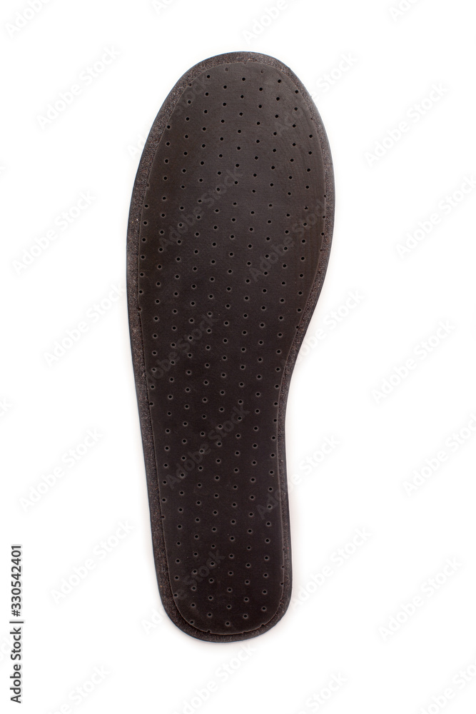 Isolated orthopedic insole on a white background. Treatment and prevention of flat feet and foot diseases. Foot care, comfort for the feet. Wear comfortable shoes. Medical insoles. Isolated orthopedic insole on a white background. Treatment and prevention of flat feet and foot diseases. Foot care, comfort for the feet. Wear comfortable shoes. Medical insoles.