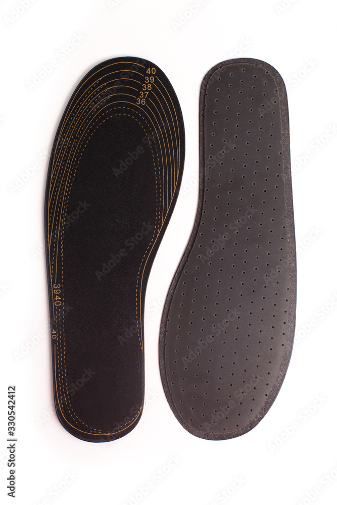 Isolated orthopedic insole on a white background. Treatment and prevention of flat feet and foot diseases. Foot care, comfort for the feet. Wear comfortable shoes. Medical insoles. Isolated orthopedic insole on a white background. Treatment and prevention of flat feet and foot diseases. Foot care, comfort for the feet. Wear comfortable shoes. Medical insoles.