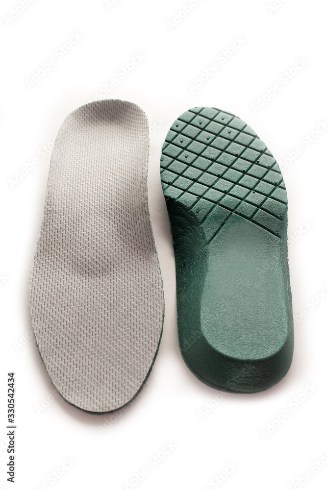 Isolated orthopedic insole on a white background. Treatment and prevention of flat feet and foot diseases. Foot care, comfort for the feet. Wear comfortable shoes. Medical insoles. Isolated orthopedic insole on a white background. Treatment and prevention of flat feet and foot diseases. Foot care, comfort for the feet. Wear comfortable shoes. Medical insoles.