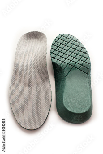 Isolated orthopedic insole on a white background. Treatment and prevention of flat feet and foot diseases. Foot care, comfort for the feet. Wear comfortable shoes. Medical insoles.