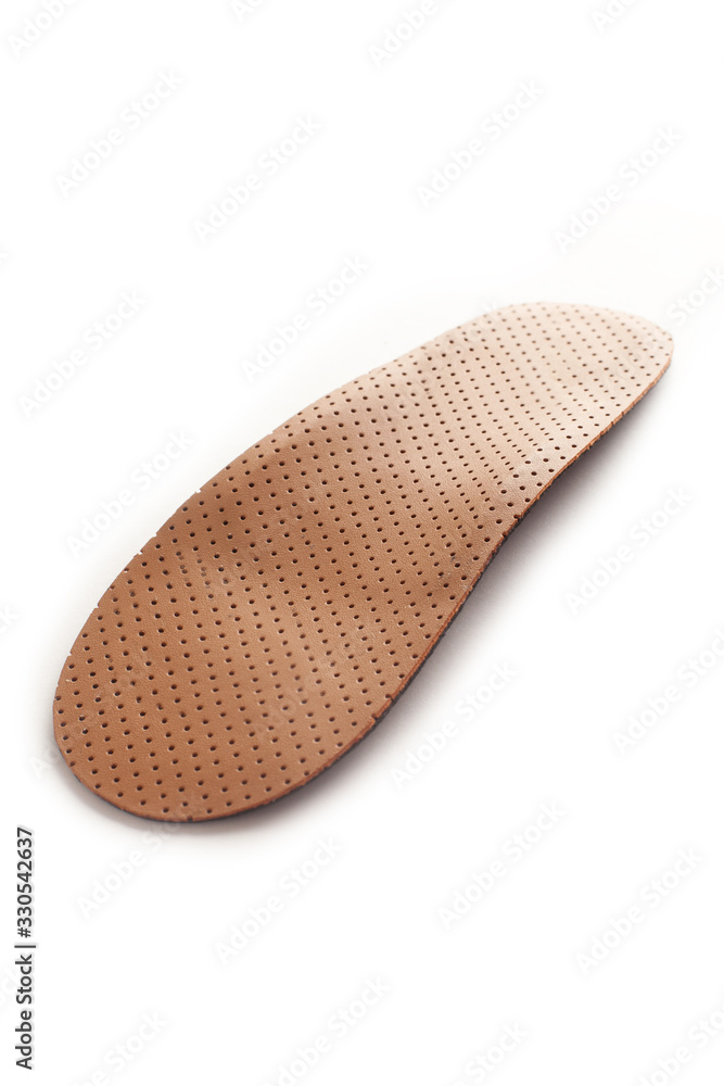 Isolated orthopedic insole on a white background. Treatment and prevention of flat feet and foot diseases. Foot care, comfort for the feet. Wear comfortable shoes. Medical insoles. Isolated orthopedic insole on a white background. Treatment and prevention of flat feet and foot diseases. Foot care, comfort for the feet. Wear comfortable shoes. Medical insoles.